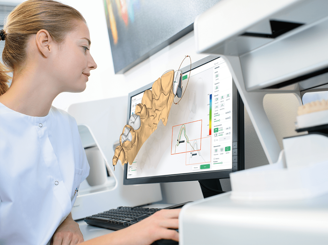 Image of a dentist looking at a hologram popping out of a monitor